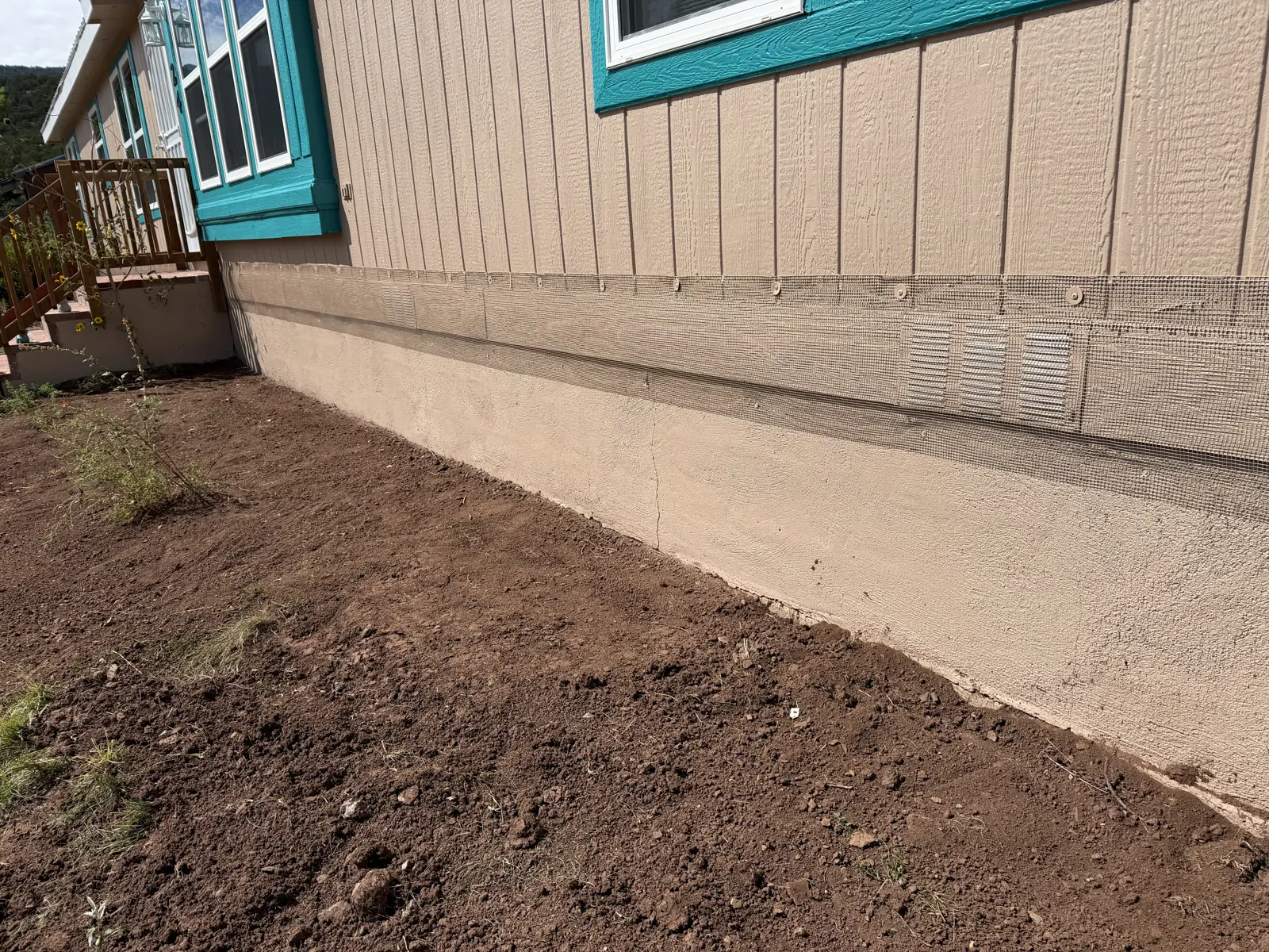 Home foundation and skirting sealed against rodents and burrowing animals